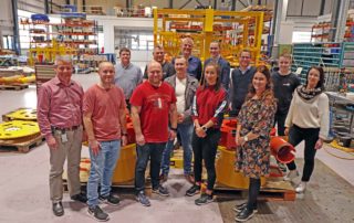 Twelve new employees at Depro March 2019 standing in the workshop.